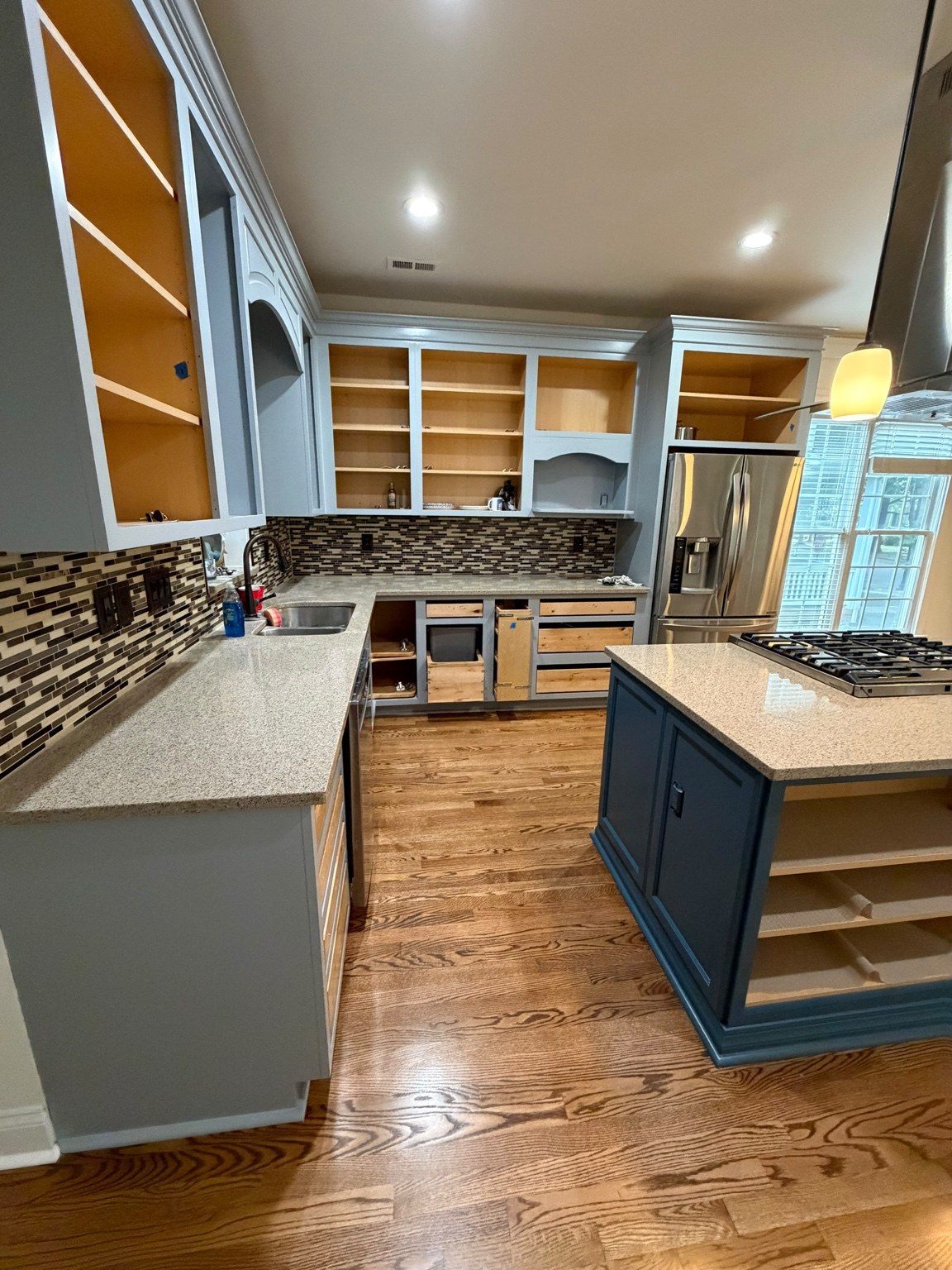 Kitchen project with white cabinets and a blue island