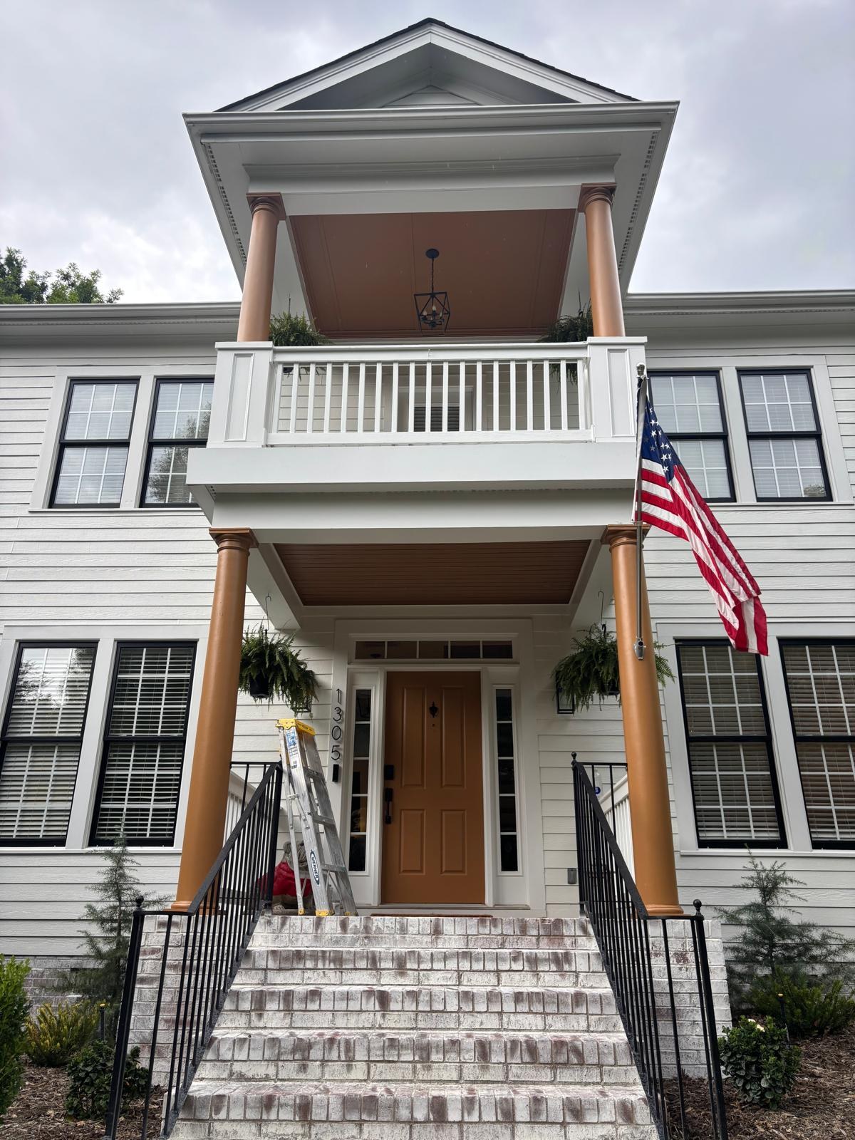 Light-colored house with porch and contrasting door